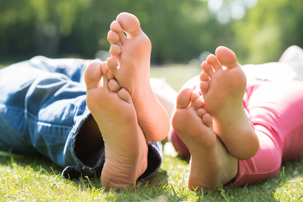 Couple Lying On Grass