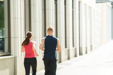 Genç çift birlikte koşuyor.