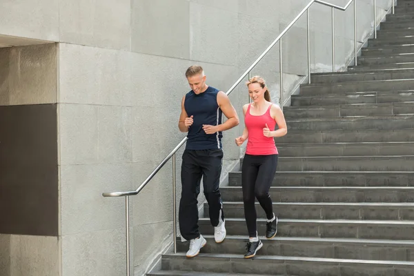 Paar läuft gemeinsam Treppe hinunter — Stockfoto