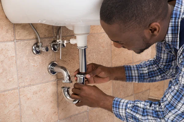 Plumber Hand Fixing Sink In Bathroom — Stock Photo, Image