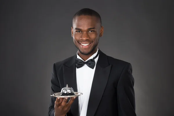 African Waiter Holding Service Bell — Stock Photo, Image