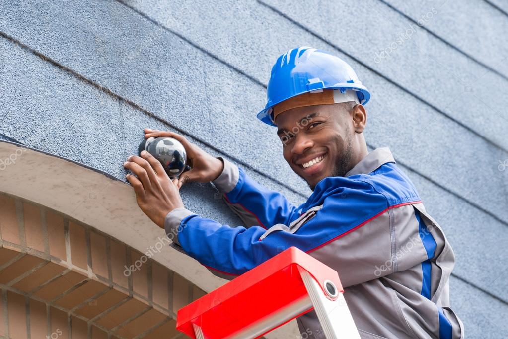 Male Technician Repairing Camera — Stock Photo © AndreyPopov 117549138