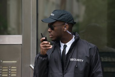 Security Guard Talking On Walkie-Talkie clipart