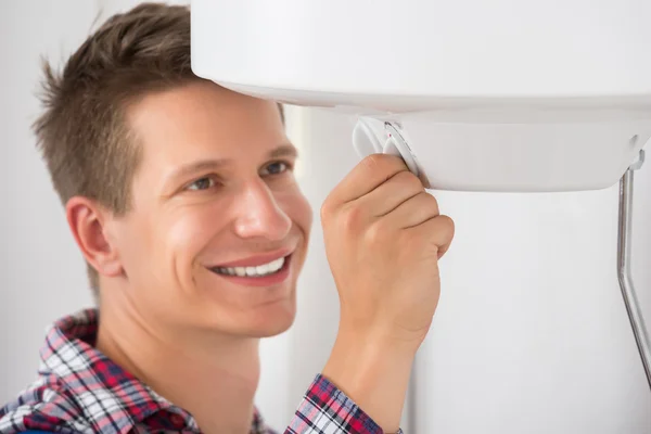 Plumber Adjusting Temperature Of Electric Boiler — Stock Photo, Image