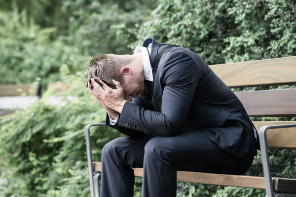 Businessman Sitting On Bench