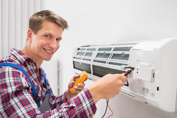 Technician Examining Air Conditioner