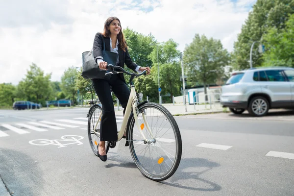 Affärskvinna med handväska rida cykel — Stockfoto