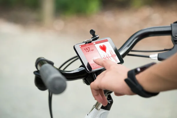 Dedo señalando el teléfono inteligente que muestra el ritmo cardíaco — Foto de Stock