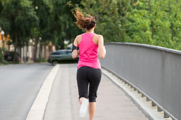 Fitness kvinna kör på trottoaren — Stockfoto