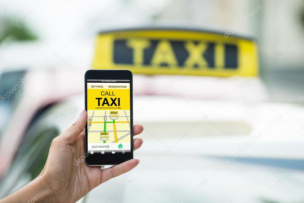 Hand Holding Mobile Phone Booking Taxi