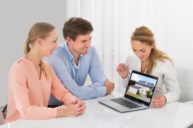 Estate Agent Showing House To Couple clipart