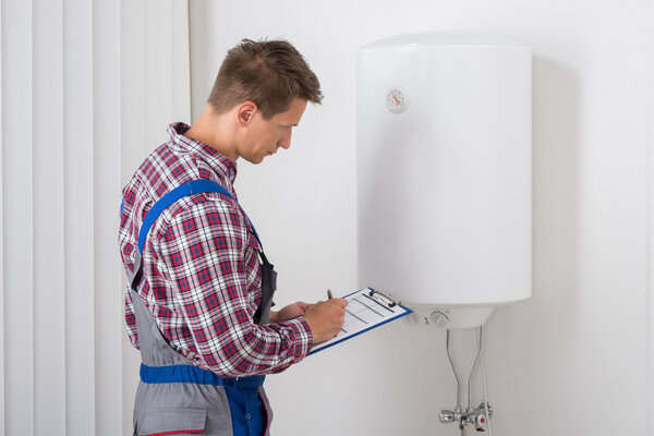 Plumber Checking Electric Boiler