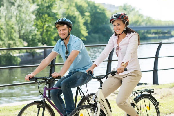 Pareja en bicicleta paseo en el parque — Foto de Stock