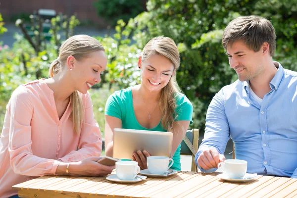 Group Of Friends Looking At Digital Tablet — Stock Photo, Image