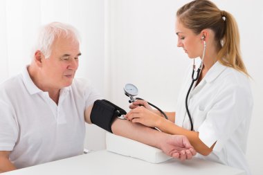 Erkek doktor erkek hastanın kan basıncı kontrol