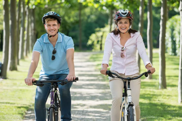 Couple chevauchant sur des vélos dans le parc — Photo