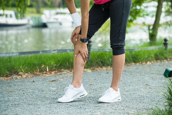 Žena jogger having bolest v ji koleno — Stock fotografie