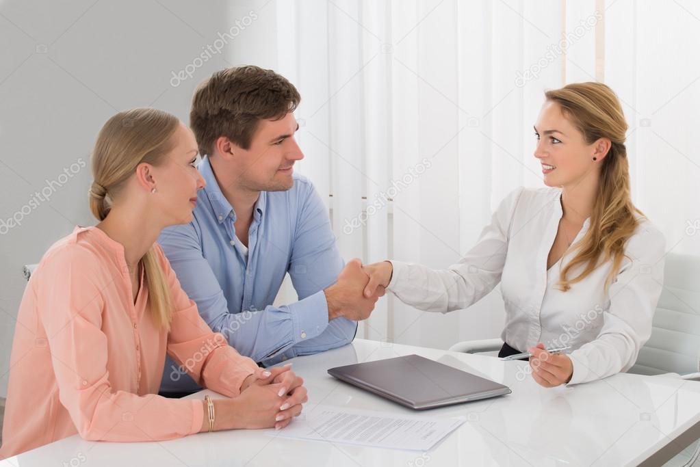 Consultant Shaking Hands With Couple