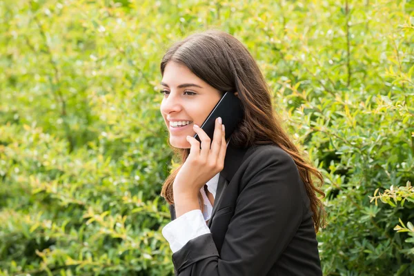 Üzletasszony ül a padon beszélő-ra mozgatható telefon — Stock Fotó