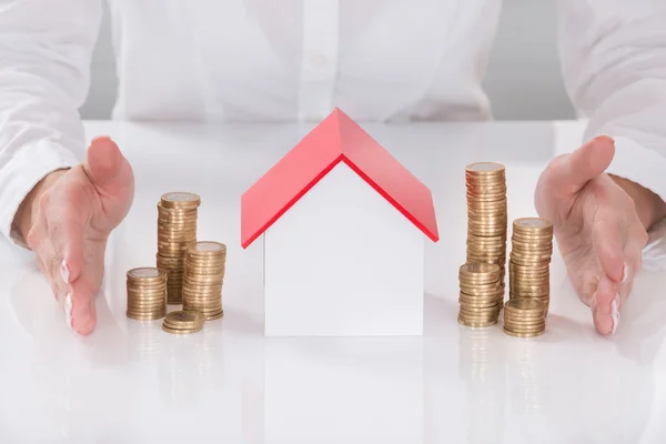 Hands Protecting House Model And Stacked Coins — Stock Photo, Image