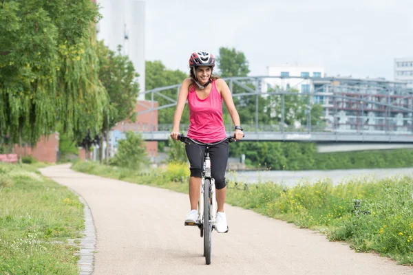Mujer joven feliz montar en bicicleta — Foto de Stock