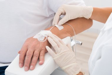 Iv Drip Inserted In Patient's Hand clipart