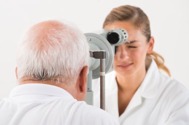 An Optometrist Doing Sight Testing For Patient clipart