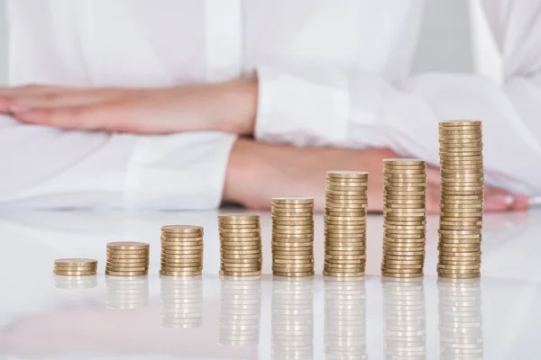 Close-up Of Businesswoman In Front Of Stacked Coins — Stock Photo, Image