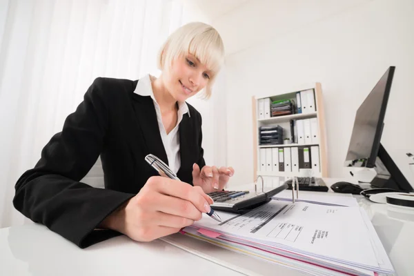 Geschäftsfrau berechnet Rechnung im Büro — Stockfoto