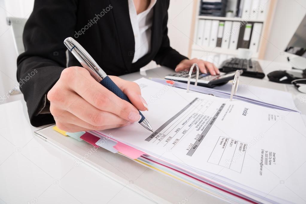 Businesswoman Hand Calculating Business Report