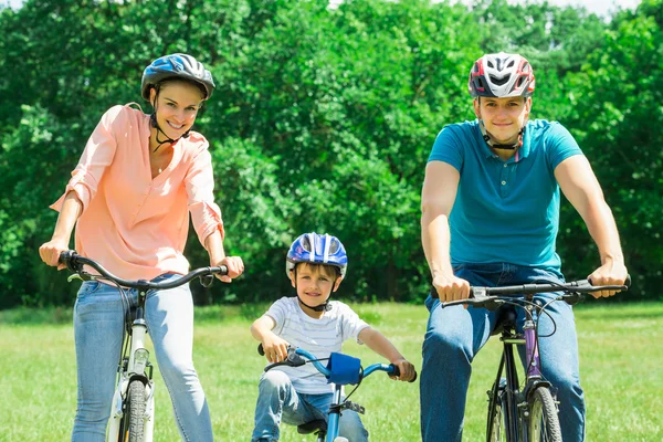 Familie fietsen in park — Stockfoto