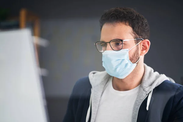 Business Employee Wearing Face Mask At Computer Desk