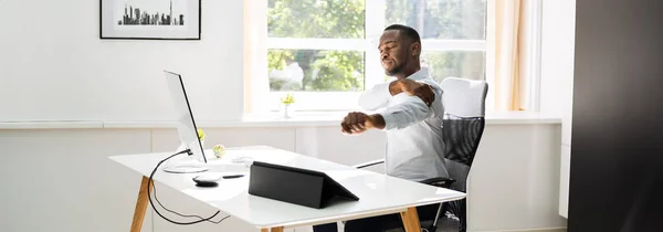 Office Stretch Exercise At Work. African American Man