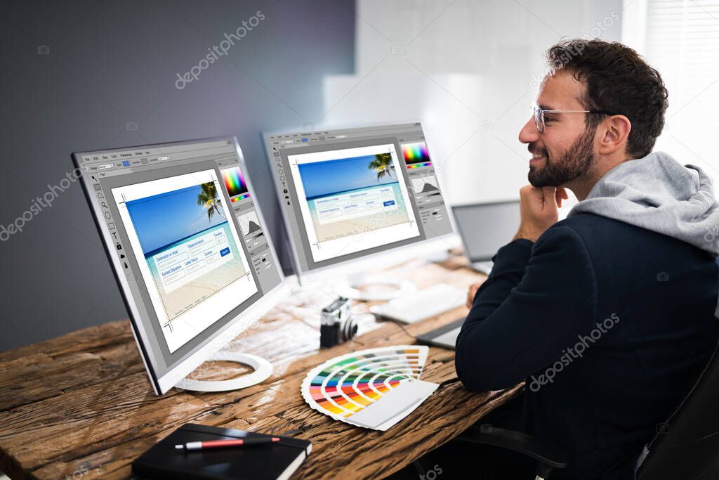 Designer Editing Photos On Multiple Computer Screens