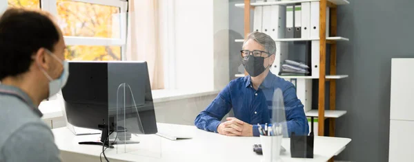 Insurance Consultant Or Lawyer In Bank With Sneeze Guard And Mask