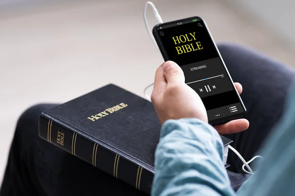 Christian Man Reading Bible Book On Phone And Praying