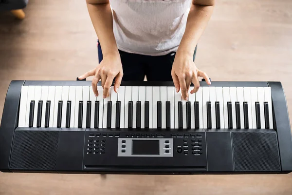 Woman Playing Music Keyboard Piano Instrument At Home