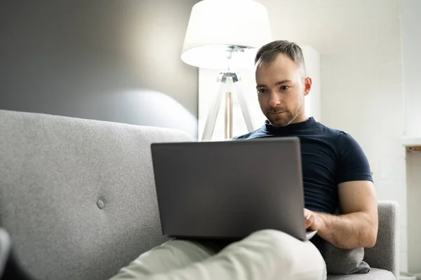 Mann Sitzt Hause Auf Sofa Und Benutzt Laptop — Stockfoto