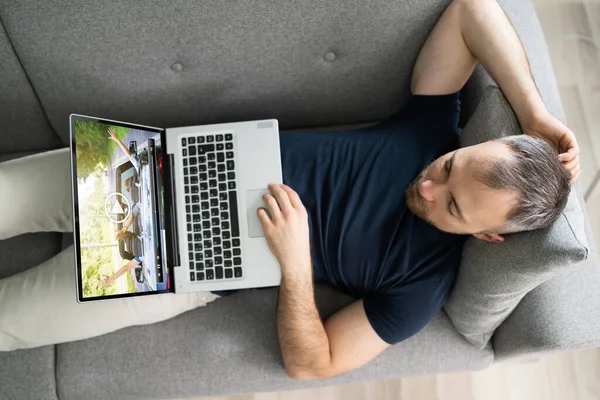 Young Man Lying Sofa Watching Video Laptop — Stock Photo, Image