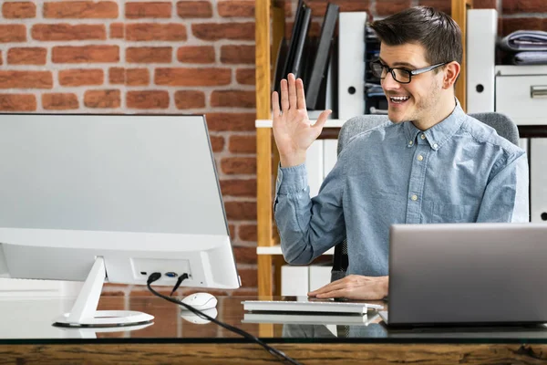 Man Raising Hand In Training Video Conference Call