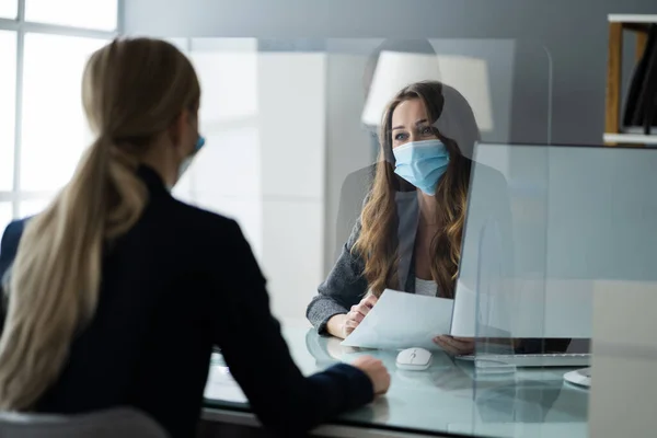 Insurance Consultant Or Lawyer In Bank With Sneeze Guard And Mask