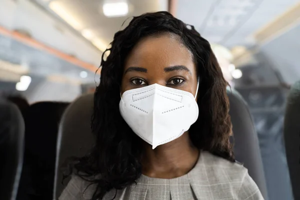 African Woman In Face Mask On Air Plane