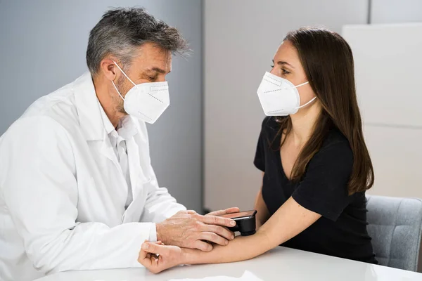 Doctor Examining Pigmented Skin Of Patient Woman