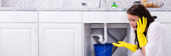 Pipe Water Leak In Kitchen Sink. Calling Plumber