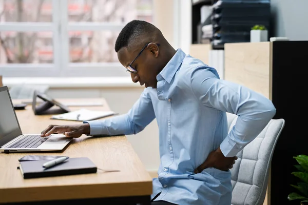 Bad Chair Posture Back Pain. African American At Desk