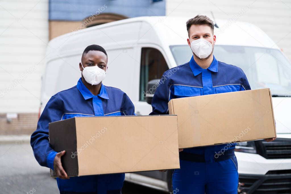 Mover Men Loading Delivery Van In Face Mask