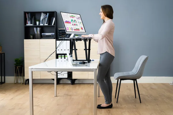 Adjustable Height Desk Stand In Office Using Computer