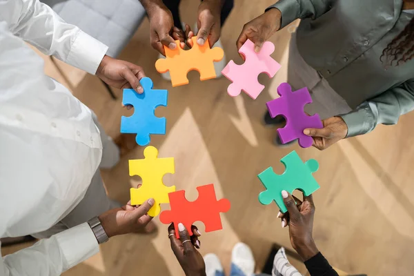 African American People Hands Holding Colorful Puzzle — Stock Photo, Image