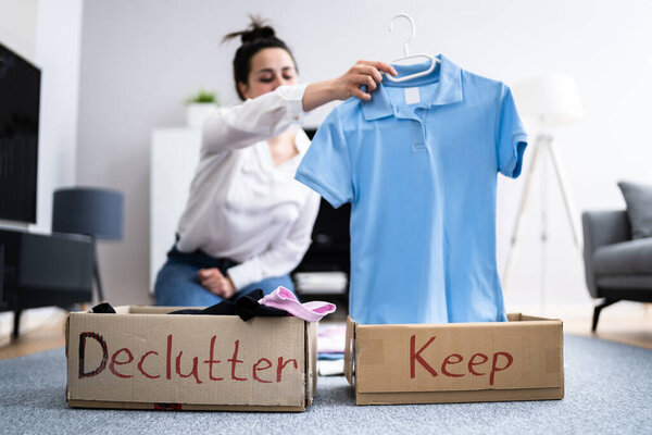 Woman Decluttering Clothes, Sorting And Cleaning Up