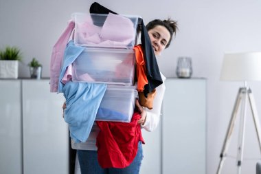 Woman Decluttering And Doing Laundry At Home clipart
